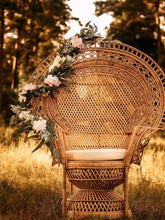 Load image into Gallery viewer, draping flower garland on wicker chair by Taylor&#39;s Touch Floral
